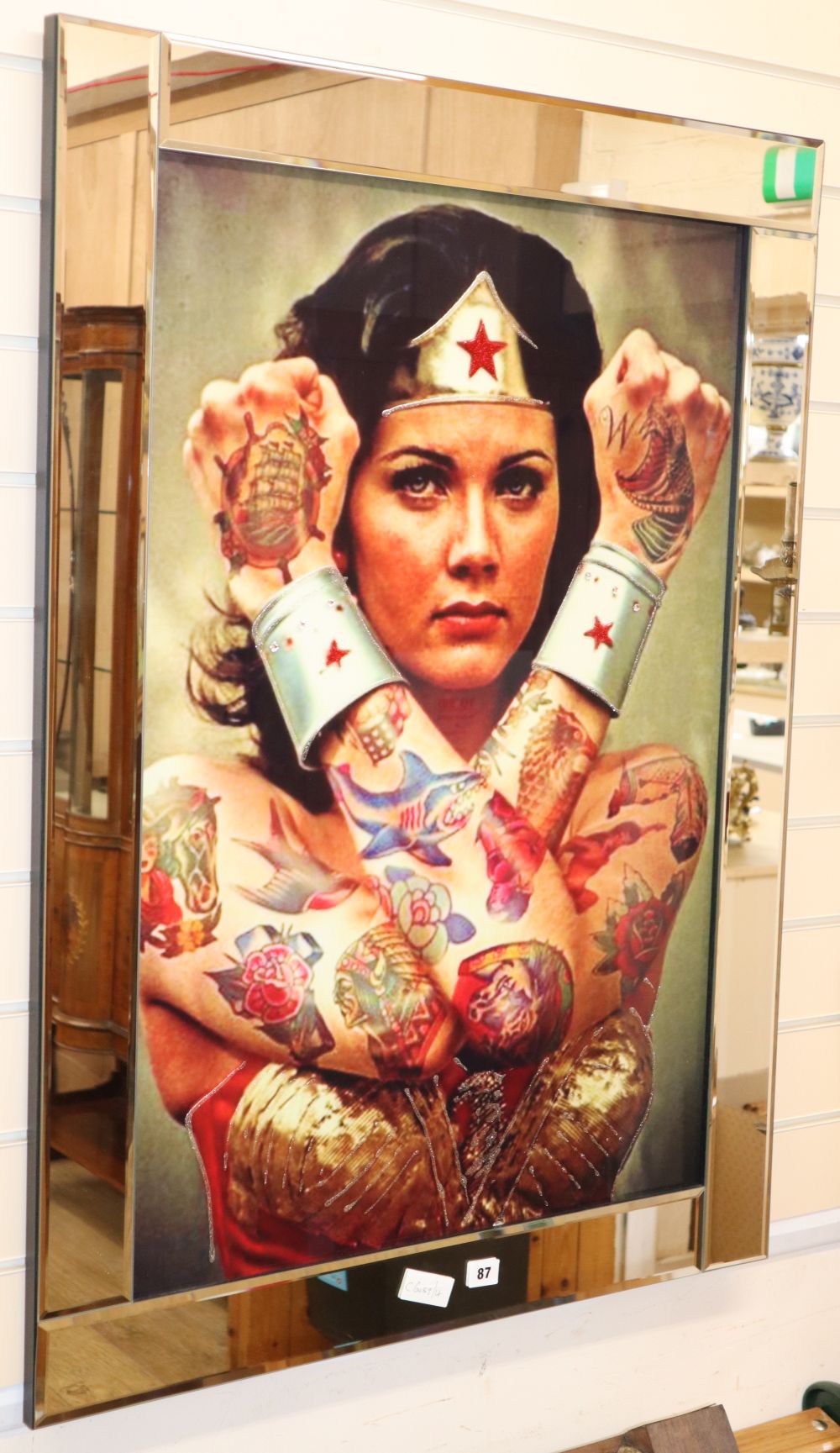 A Wonder Woman print, mirror framed, 75 x 105cm